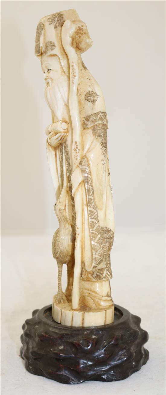 A Japanese walrus ivory figure of Fukurokuju, early 20th century, height 24.5cm incl. wood stand